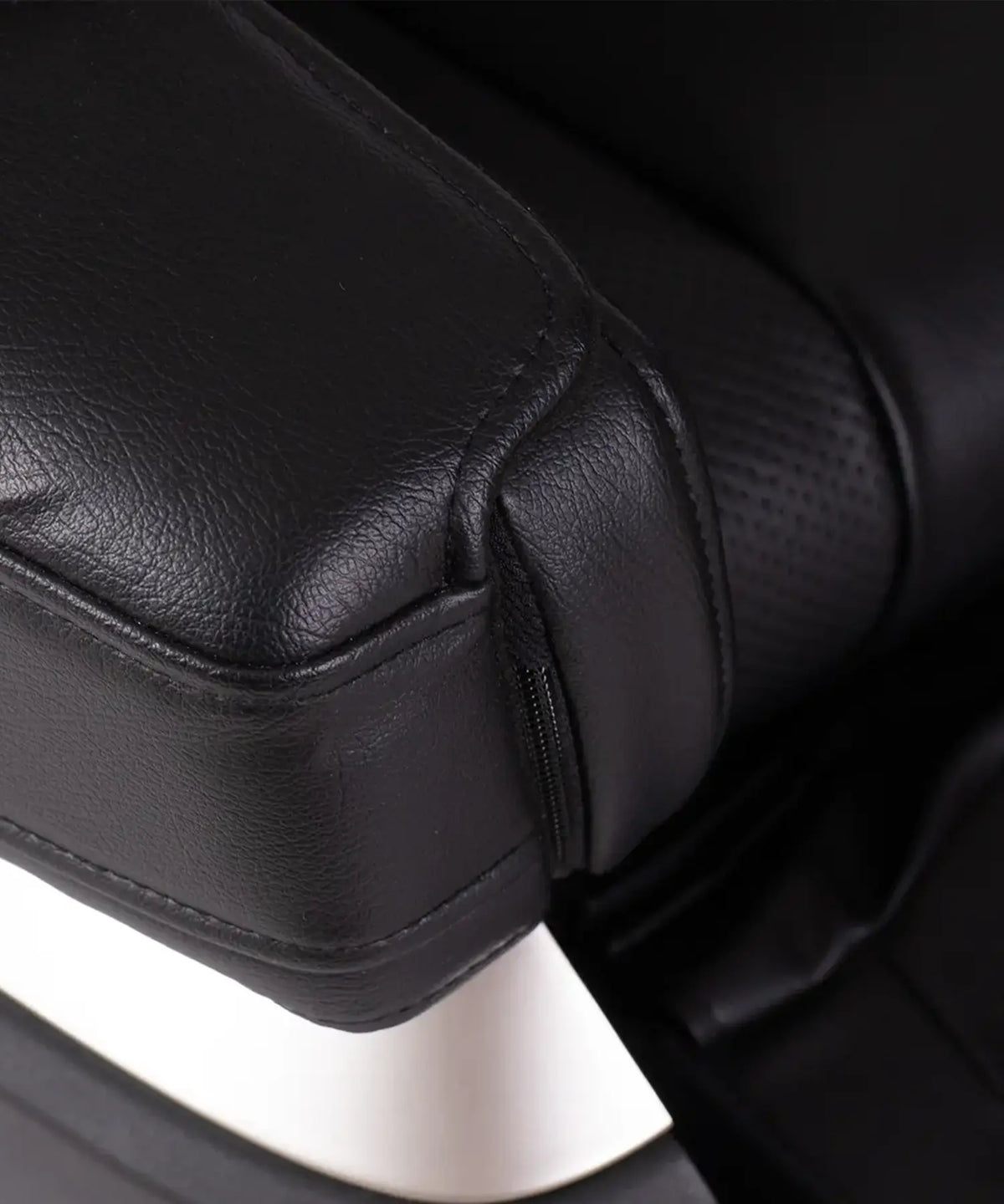 Detailed view of the Fujiiryoki JP-2000 black massage chair showcasing the leather armrest, integrated zip pocket and refined finish.